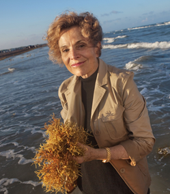 Sylvia Earle standing in the surf